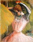 Dancer arranging her hair by Edgar Degas